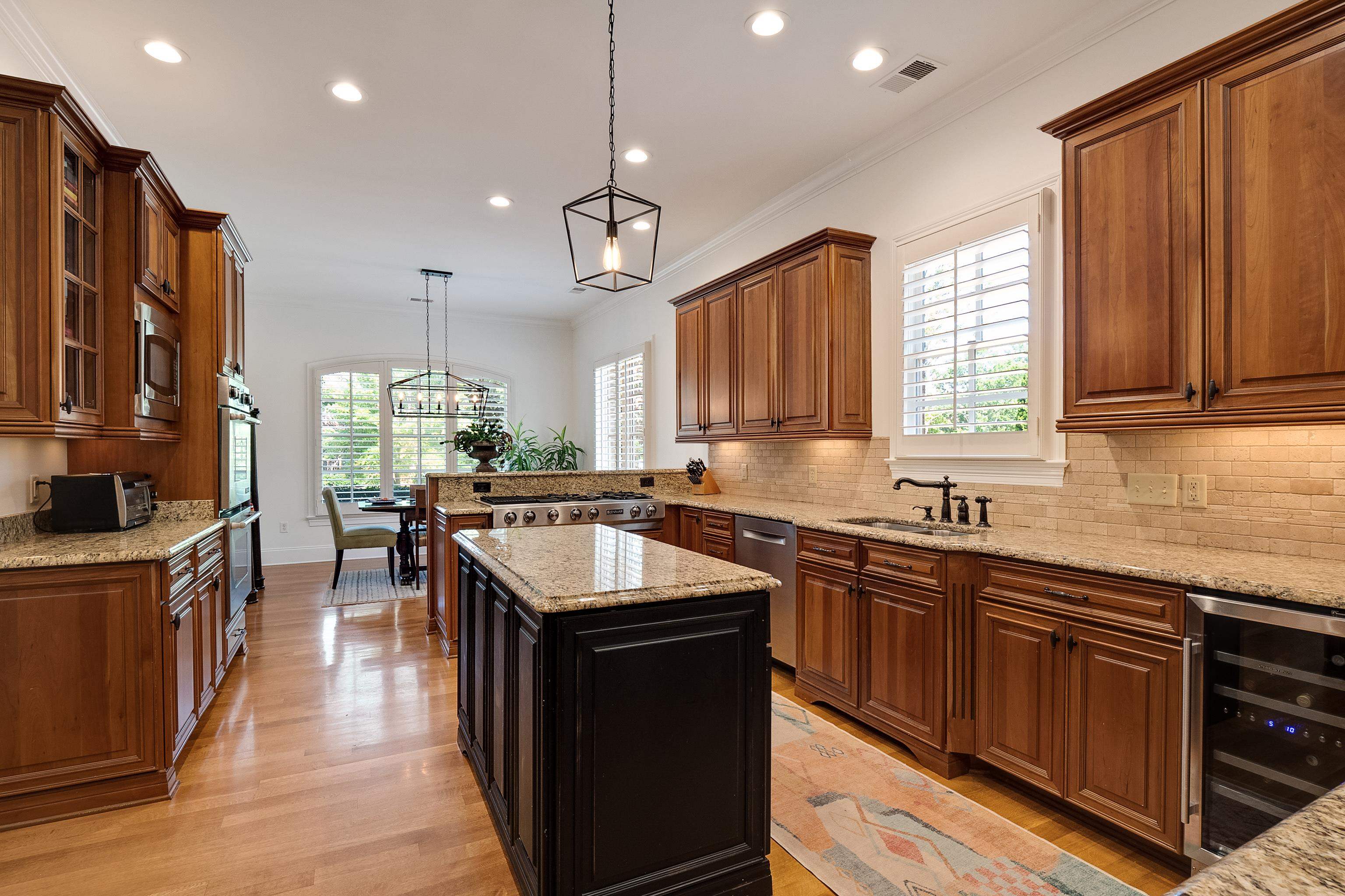 3174 Wetherby Drive Germantown, TN 38139 - Photo 12 of 40 a kitchen with stainless steel appliances granite countertop a sink a stove and a refrigerator