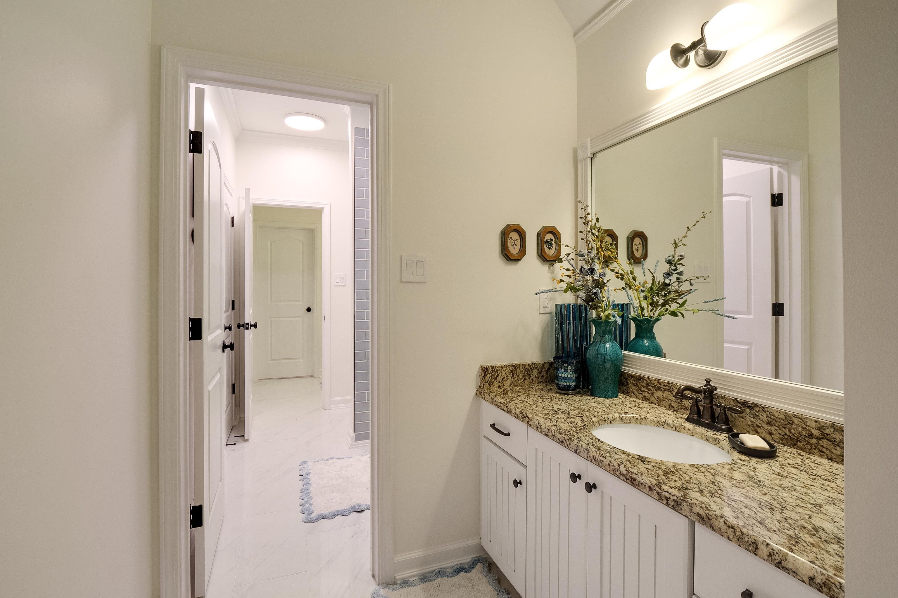 3174 Wetherby Drive Germantown, TN 38139 - Photo 29 of 40 a bathroom with a granite countertop sink and a mirror