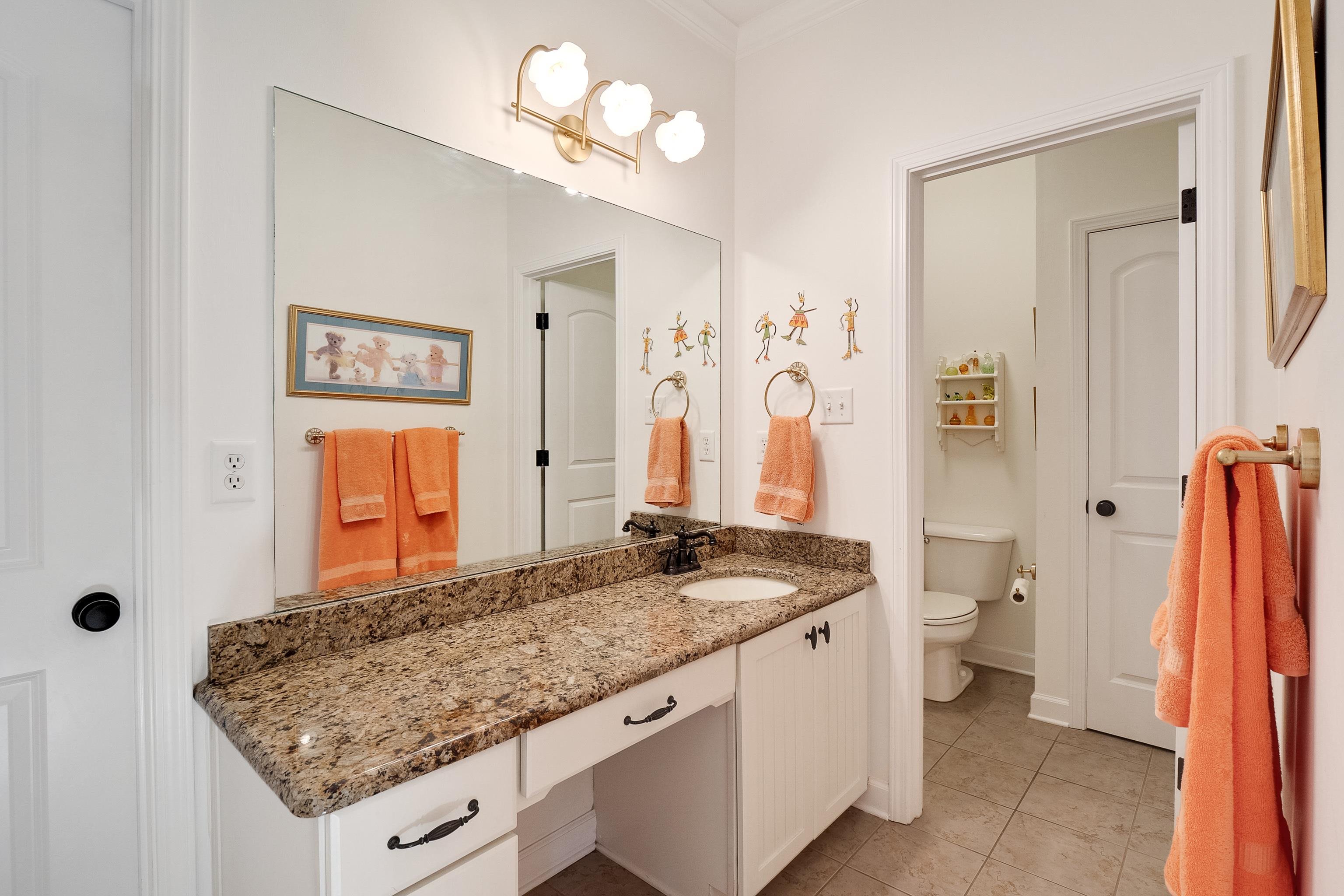 3174 Wetherby Drive Germantown, TN 38139 - Photo 33 of 40 a bathroom with a granite countertop sink a toilet and a mirror