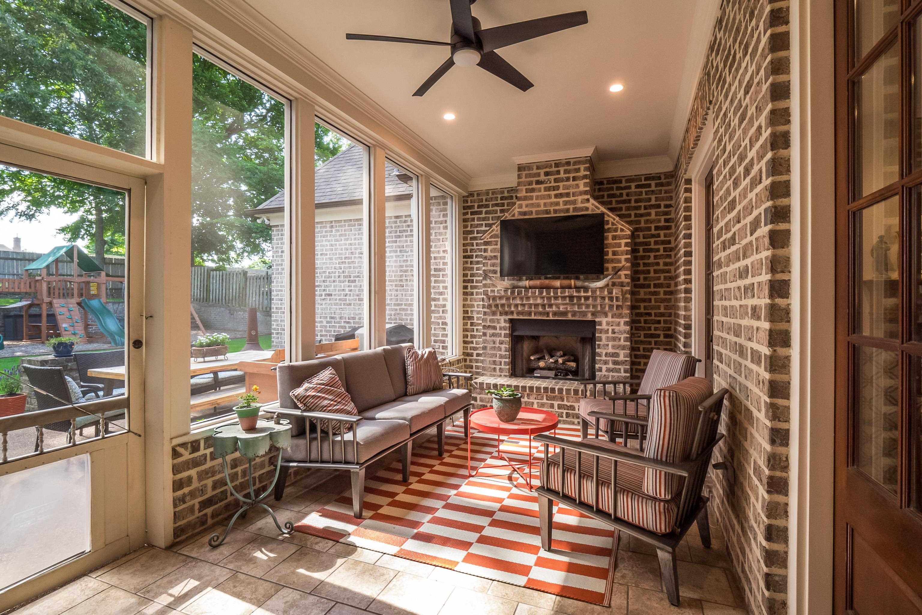 3174 Wetherby Drive Germantown, TN 38139 - Photo 35 of 40 a living room with furniture a flat screen tv and a fireplace