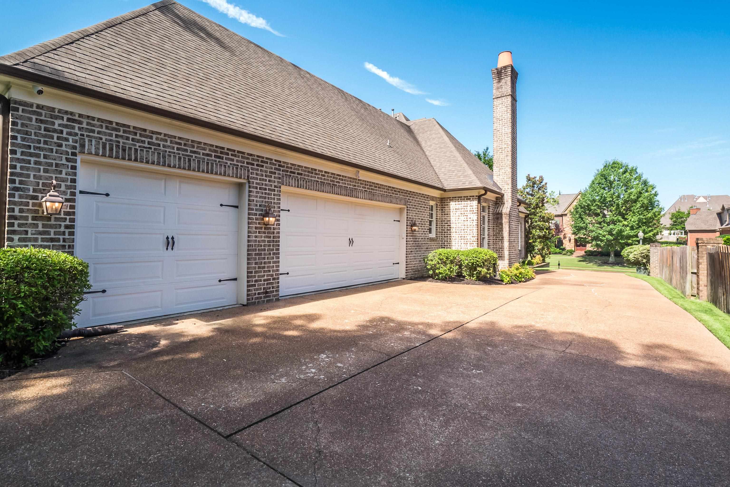 3174 Wetherby Drive Germantown, TN 38139 - Photo 39 of 40 a front view of a house with a yard and garage