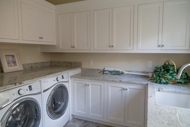 44 Shell Drive North Chatham, MA 02650 - Photo 13 of 34 a kitchen with granite countertop white cabinets and washer