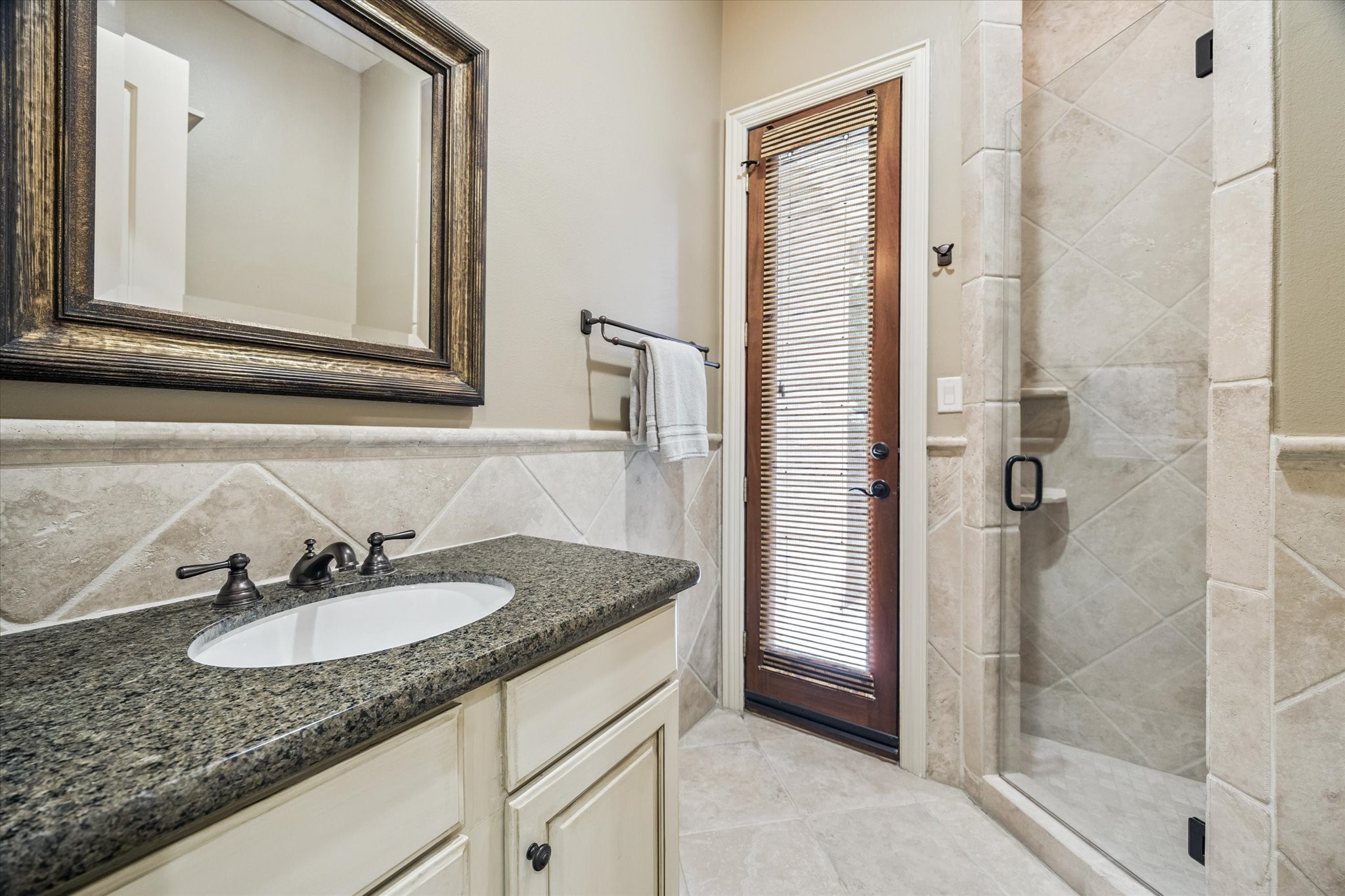 570 Lanecrest Lane Houston, TX 77024 - Photo 21 of 36 a bathroom with a granite countertop sink and a mirror