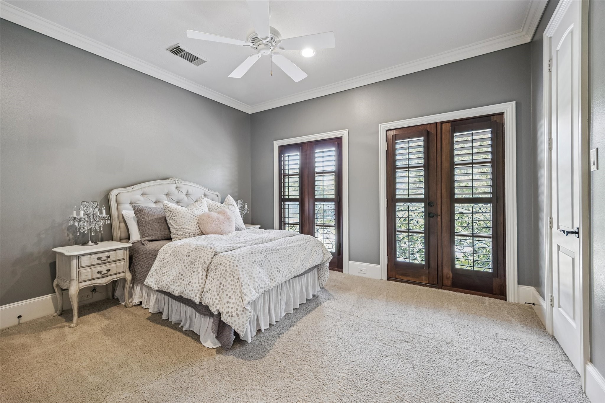 570 Lanecrest Lane Houston, TX 77024 - Photo 29 of 36 a spacious bedroom with a bed a ceiling fan and a large window