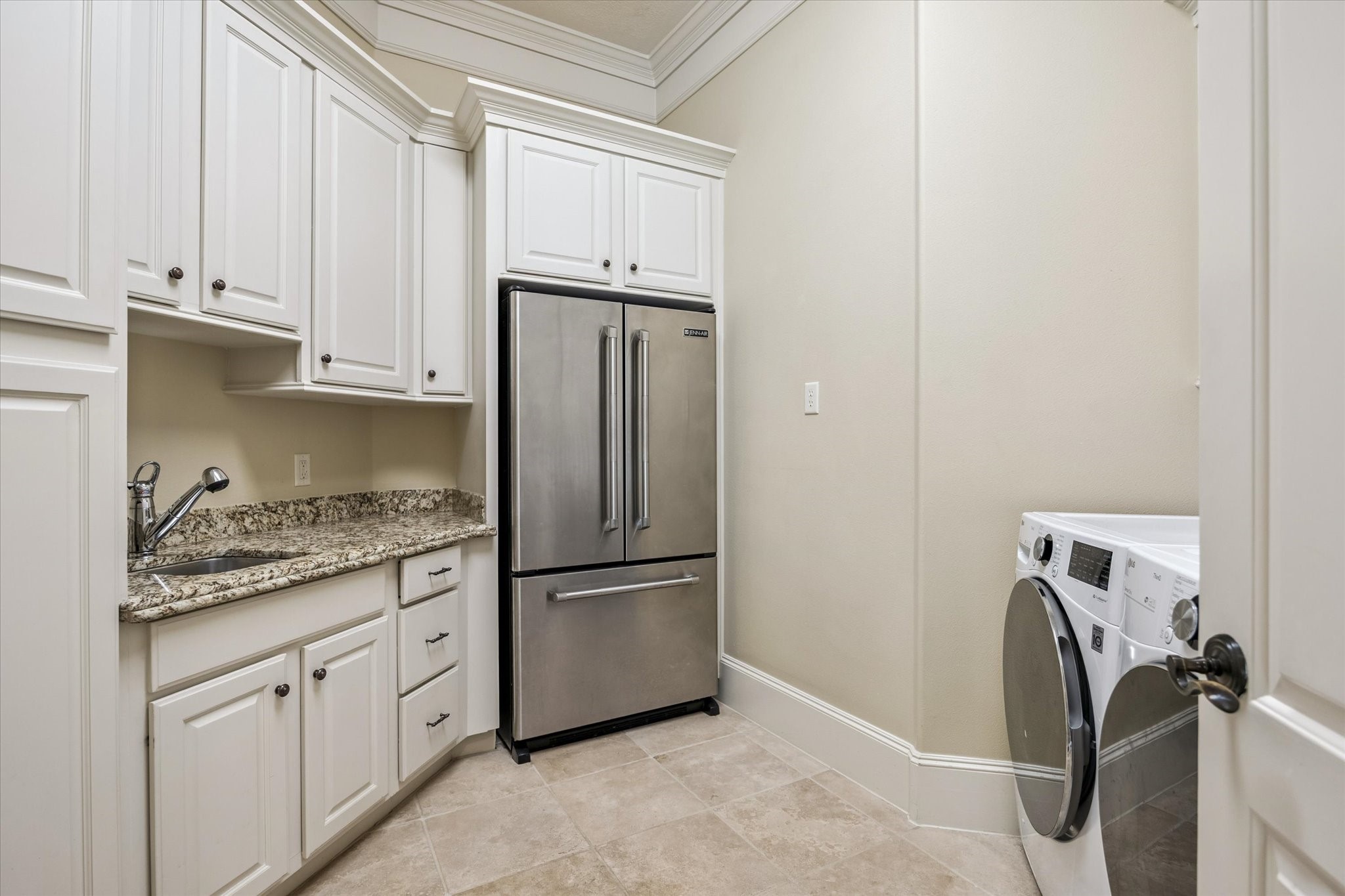 570 Lanecrest Lane Houston, TX 77024 - Photo 32 of 36 a kitchen with granite countertop white cabinets and stainless steel appliances