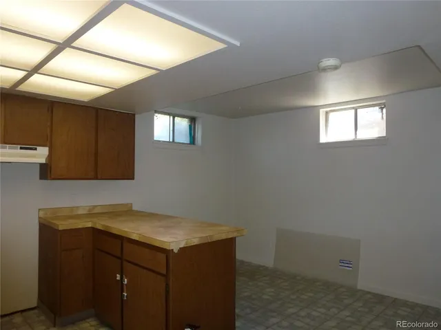 a kitchen with sink and cabinets
