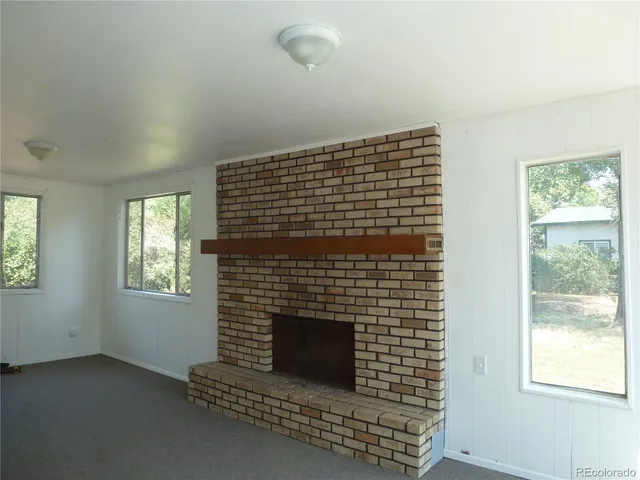 an empty room with windows and entrance