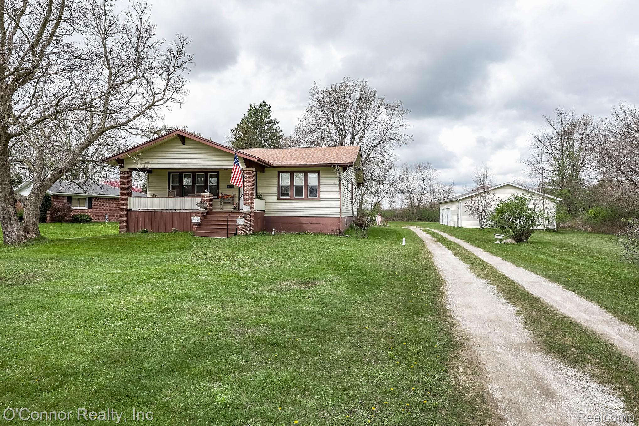 3323 Kinney Road Emmett, MI 48022 - Photo 25 of 29 Ranch-style residence featuring a covered front porch with brick pillars and a gable roofline