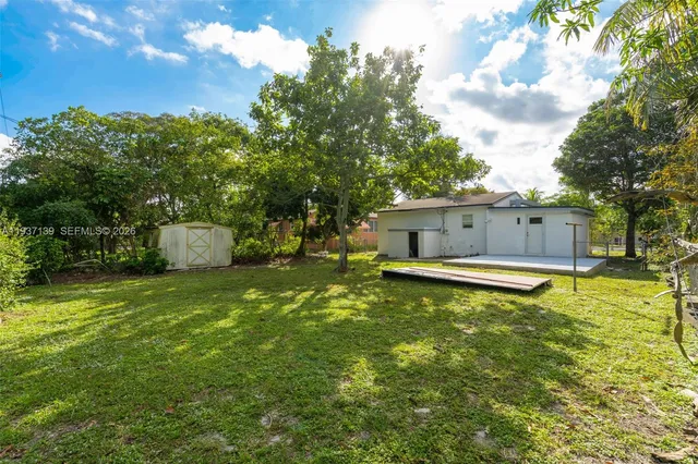 a front view of a house with a yard garage and table