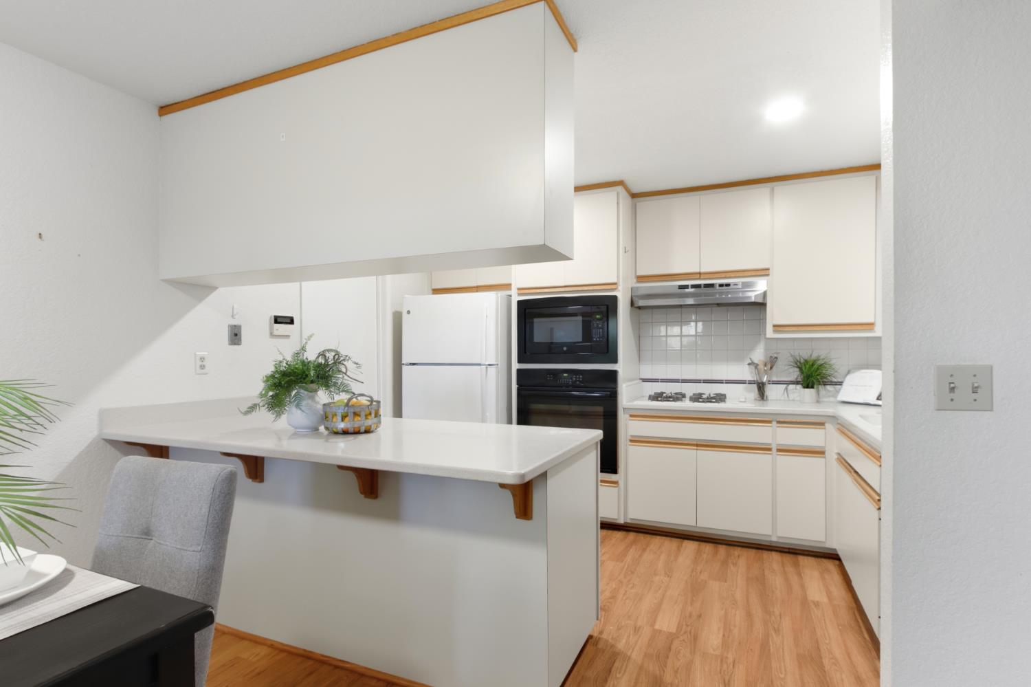 2033 Manet Place Davis, CA 95618 - Photo 16 of 56 Two tone kitchen with a breakfast bar area peninsula,
