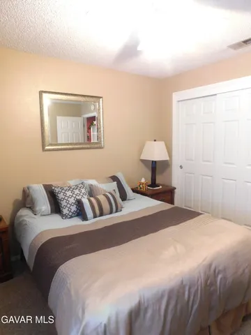 a bedroom with a bed and a lamp