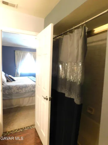 a bathroom with a glass shower door