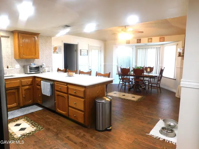 a open kitchen with a sink dining table and chairs