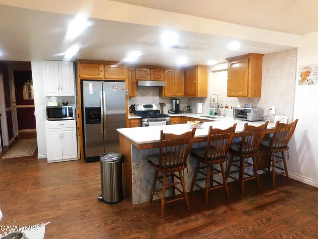 a large kitchen with a table and chairs