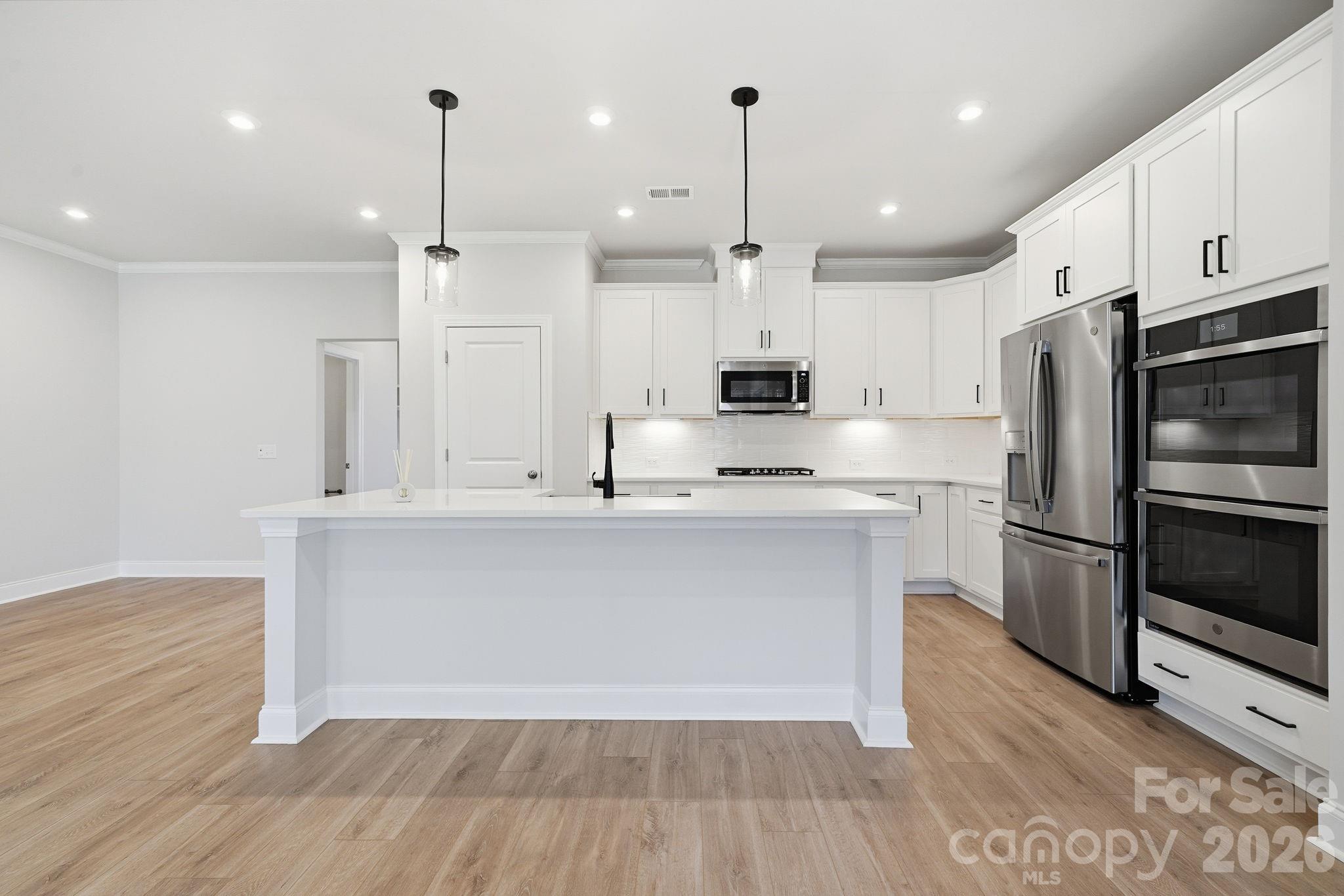 1827 Viewfield Road Fort Mill, SC 29708 - Photo 10 of 43 a kitchen with kitchen island a white counter space appliances and cabinets