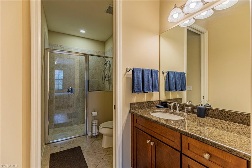 9063 Capistrano Street North, Unit 4405 Naples, FL 34113 - Photo 11 of 37 a bathroom with a sink and a mirror