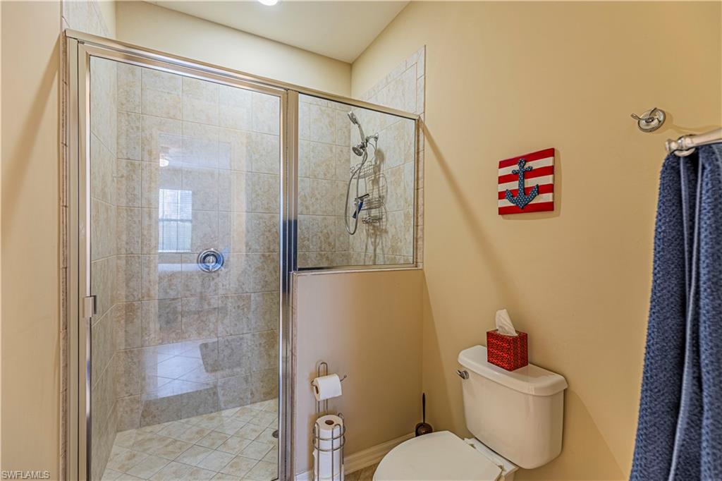 9063 Capistrano Street North, Unit 4405 Naples, FL 34113 - Photo 12 of 37 a bathroom with a shower and a toilet