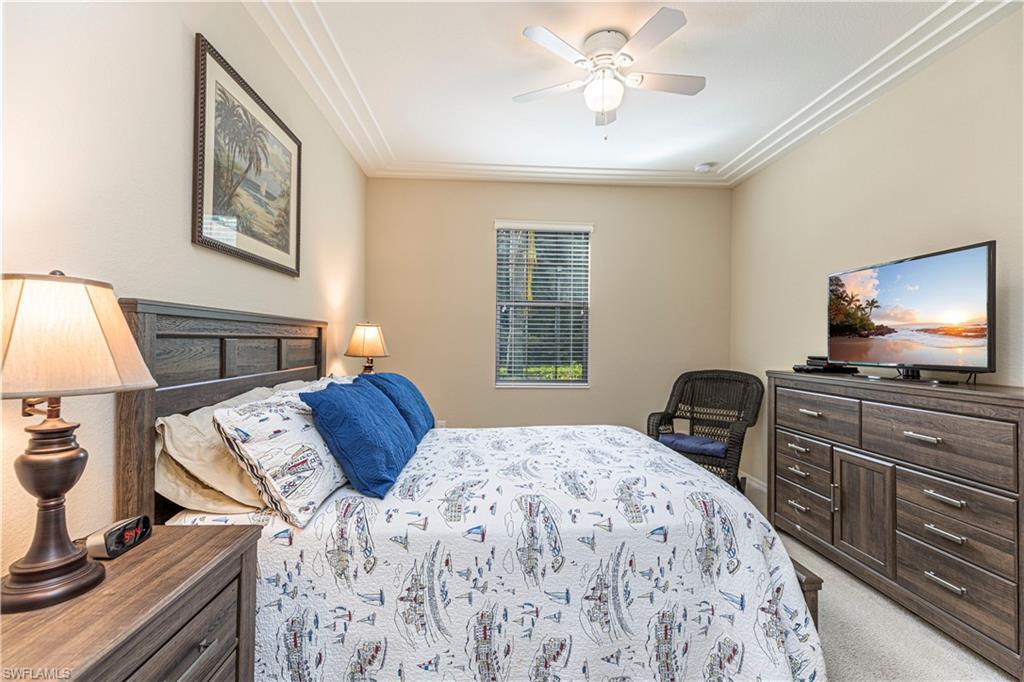9063 Capistrano Street North, Unit 4405 Naples, FL 34113 - Photo 13 of 37 a bedroom with a bed and a flat screen tv