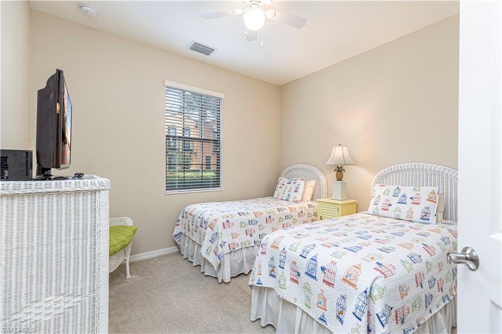 9063 Capistrano Street North, Unit 4405 Naples, FL 34113 - Photo 15 of 37 a bedroom with two beds and a window