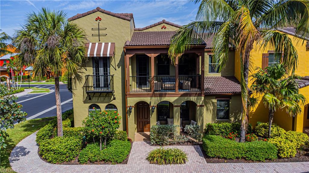 9063 Capistrano Street North, Unit 4405 Naples, FL 34113 - Photo 17 of 37 a front view of a house with garden