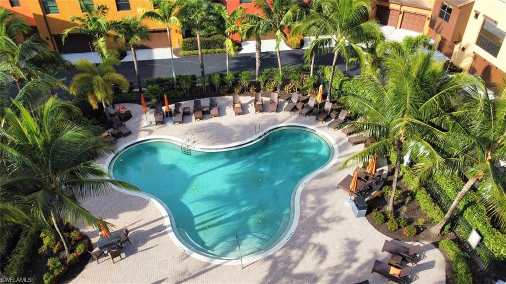 9063 Capistrano Street North, Unit 4405 Naples, FL 34113 - Photo 19 of 37 a view of a swimming pool with a patio