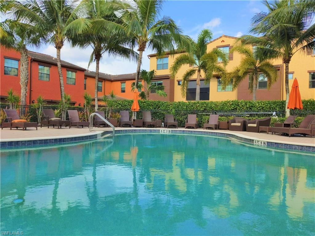 9063 Capistrano Street North, Unit 4405 Naples, FL 34113 - Photo 21 of 37 a view of swimming pool with outdoor seating and city view