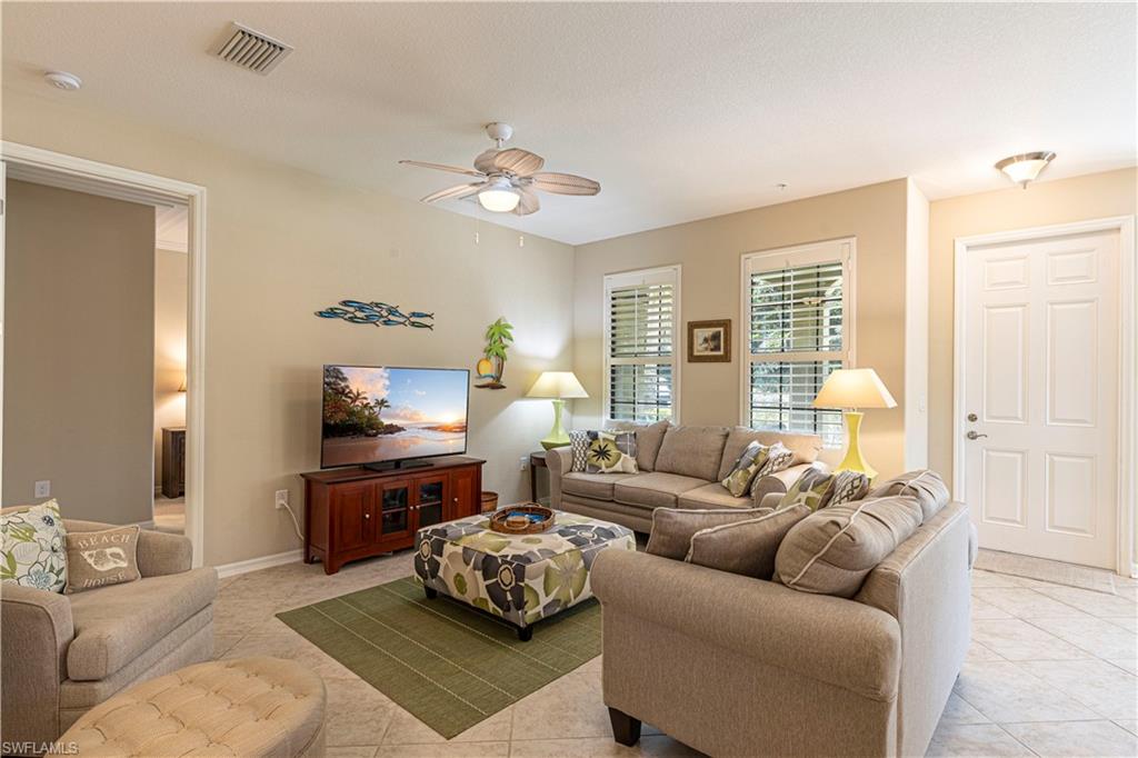 9063 Capistrano Street North, Unit 4405 Naples, FL 34113 - Photo 5 of 37 a bedroom with a bed couch and window