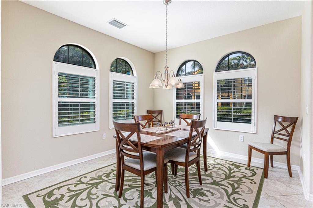 9063 Capistrano Street North, Unit 4405 Naples, FL 34113 - Photo 9 of 37 a view of a dining room with furniture window and wooden floor