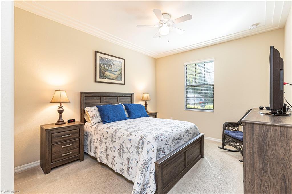 9063 Capistrano Street North, Unit 4405 Naples, FL 34113 - Photo 10 of 37 a bedroom with a bed and a flat screen tv