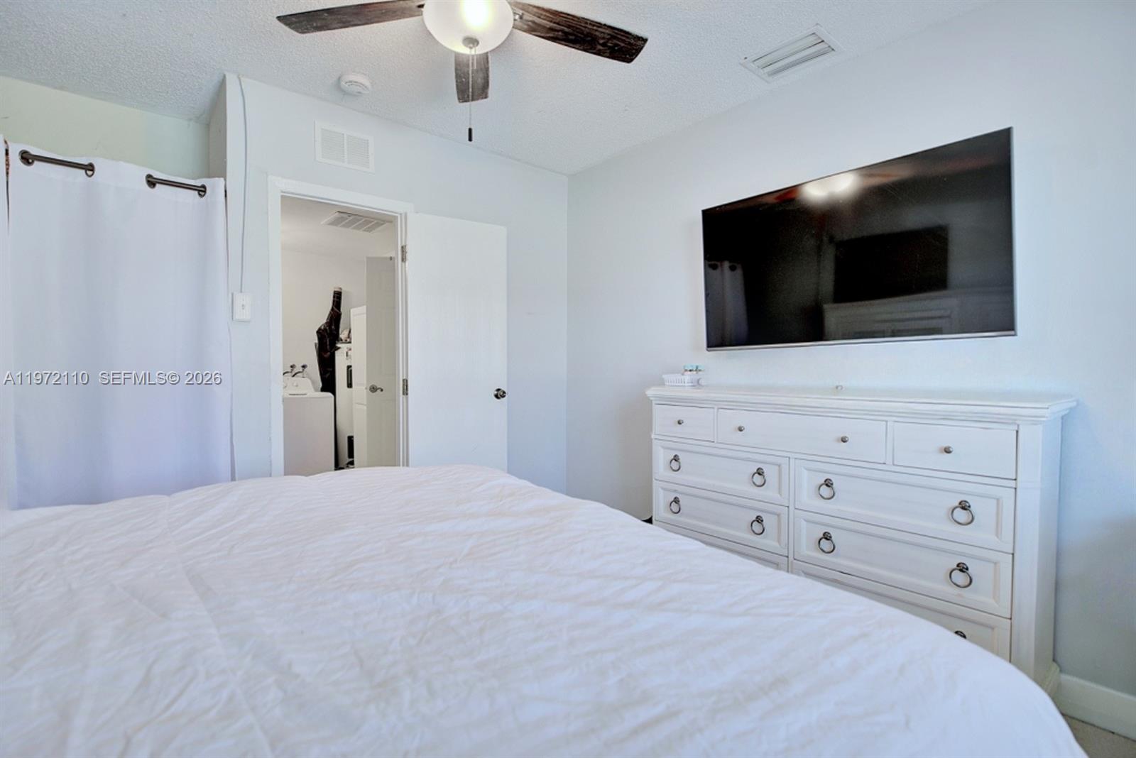 4131 Bianca Street Sebring, FL 33872 - Photo 17 of 30 a bedroom with a bed and a flat screen tv