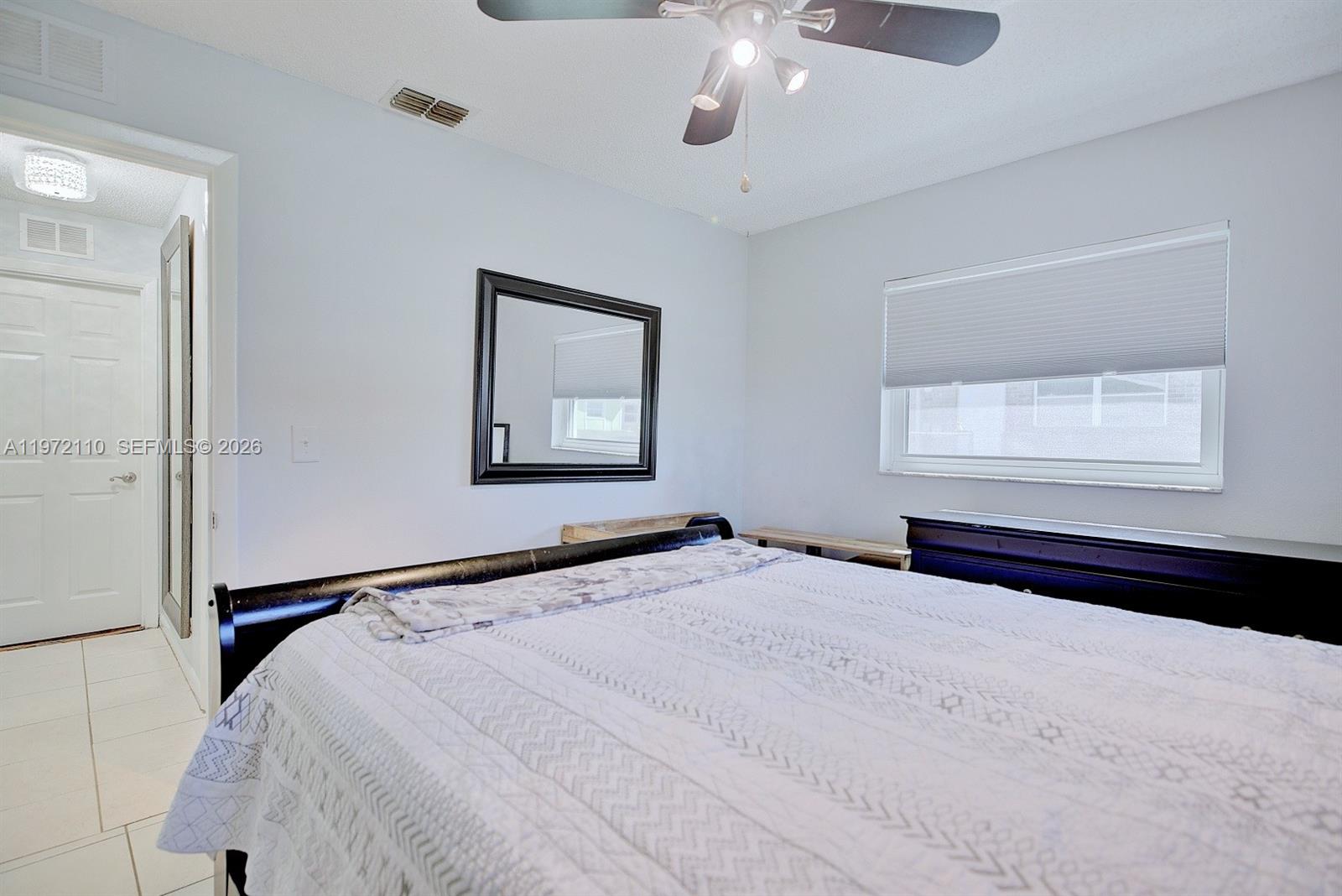 4131 Bianca Street Sebring, FL 33872 - Photo 18 of 30 a bedroom with a bed and a painting on the wall