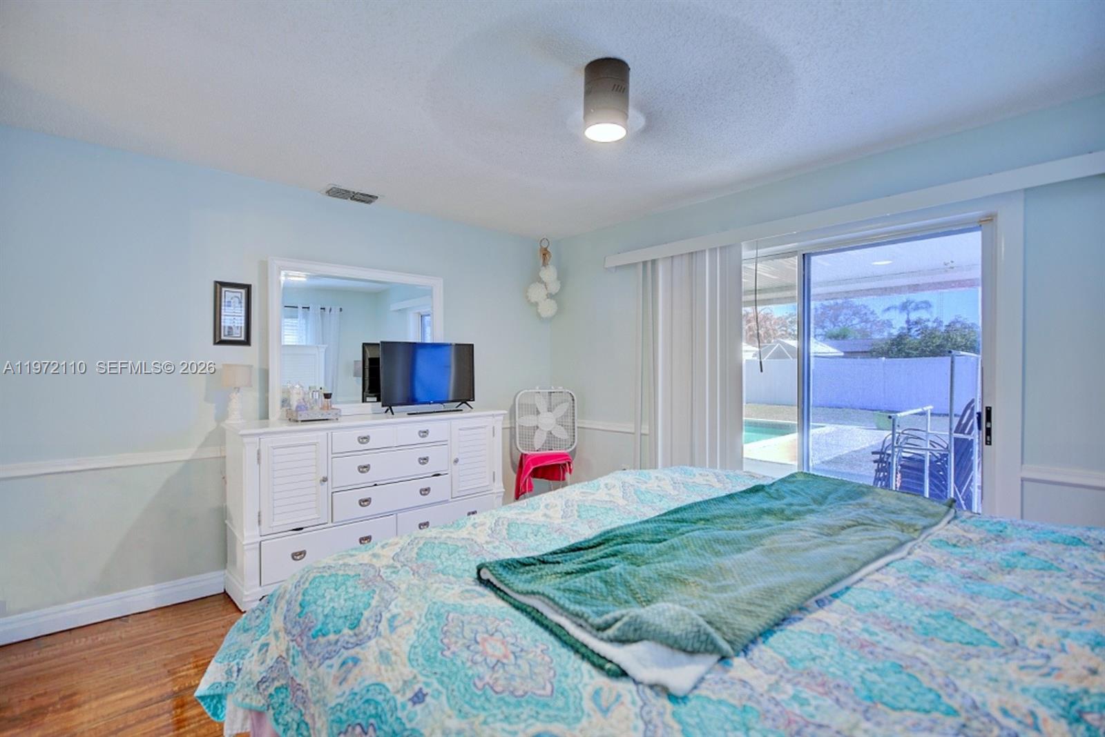 4131 Bianca Street Sebring, FL 33872 - Photo 22 of 30 a bedroom with a bed and a dresser