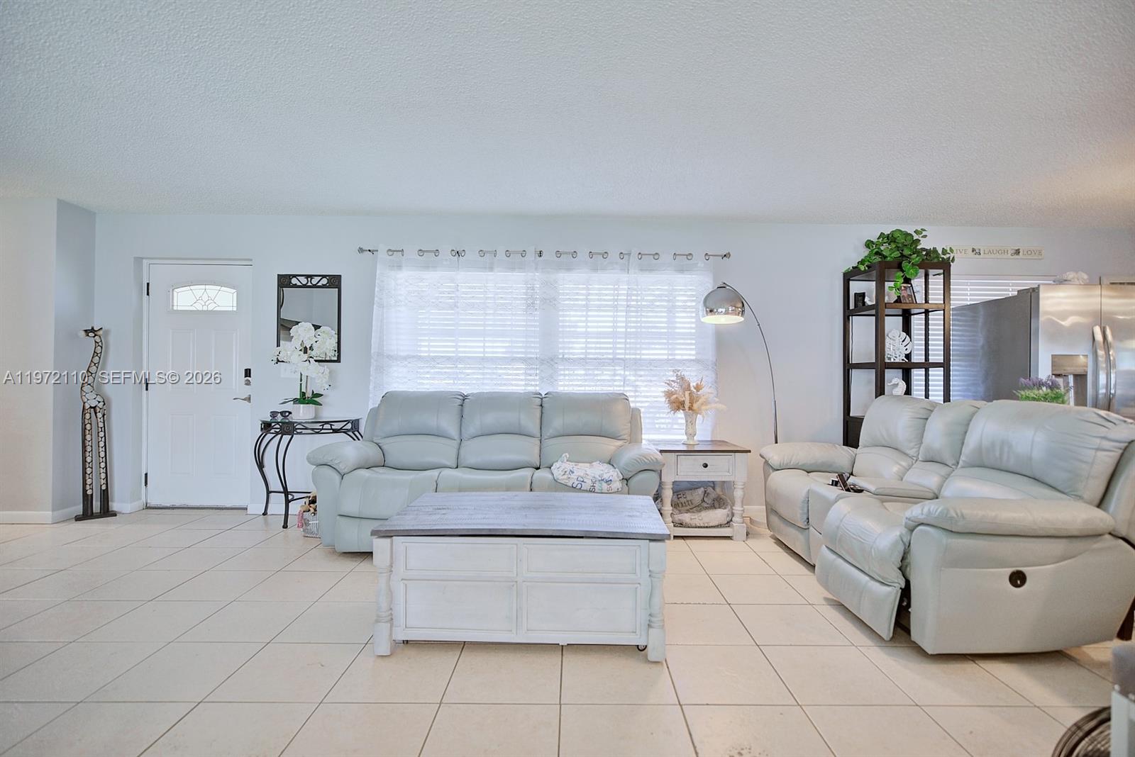 4131 Bianca Street Sebring, FL 33872 - Photo 5 of 30 a living room with furniture and a potted plant