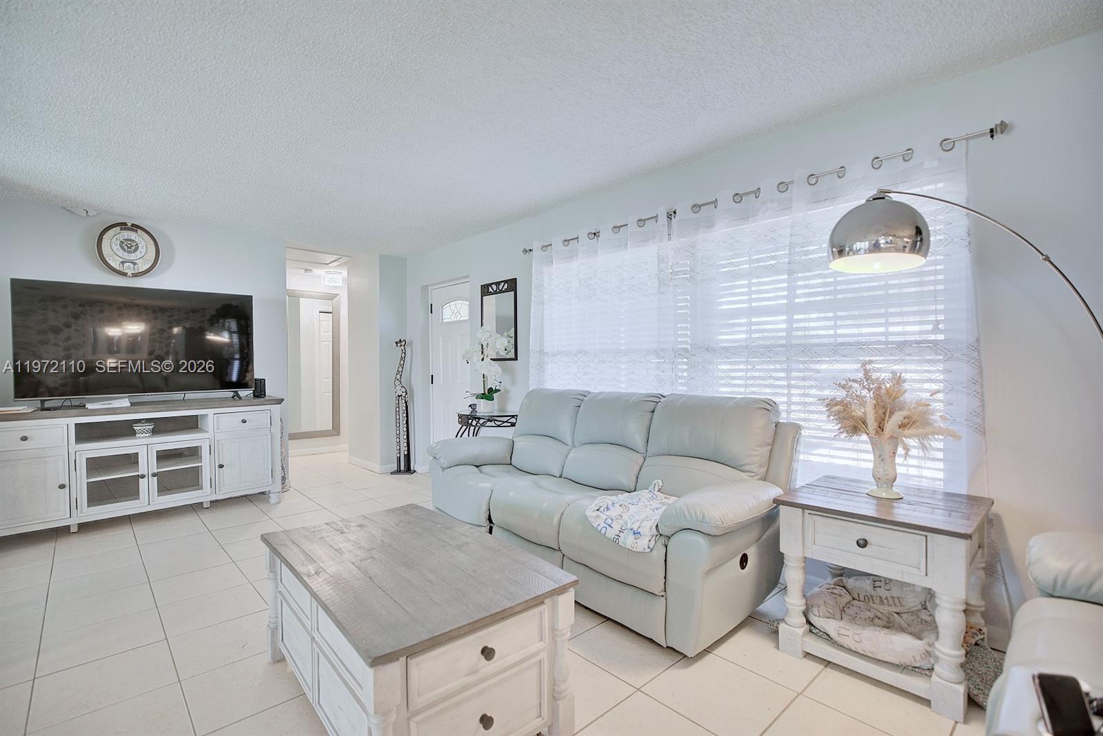 4131 Bianca Street Sebring, FL 33872 - Photo 6 of 30 a living room with furniture and a flat screen tv