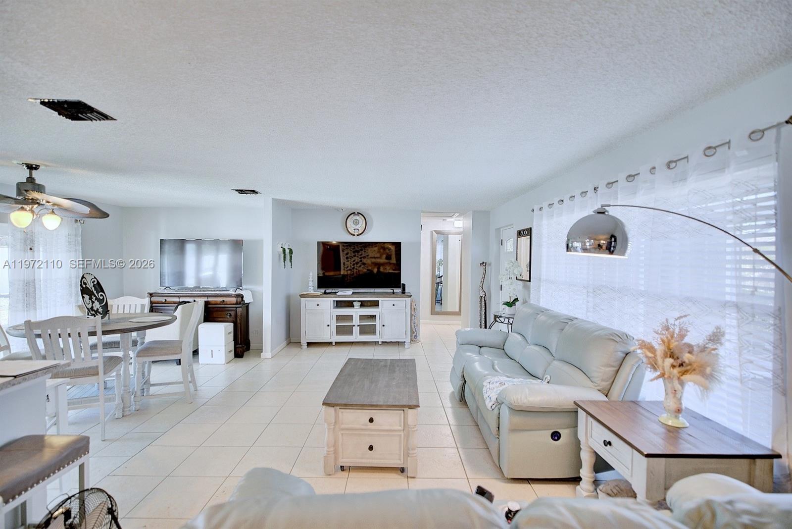4131 Bianca Street Sebring, FL 33872 - Photo 7 of 30 a living room with furniture and a flat screen tv