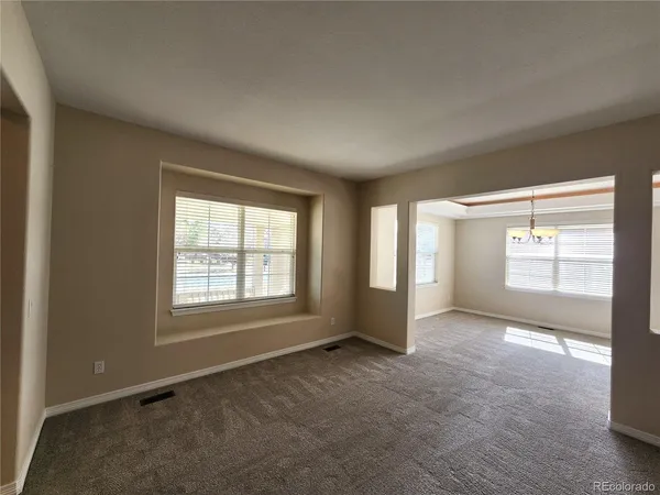 an empty room with windows and closet
