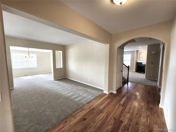 a view of a room with wooden floor and a window