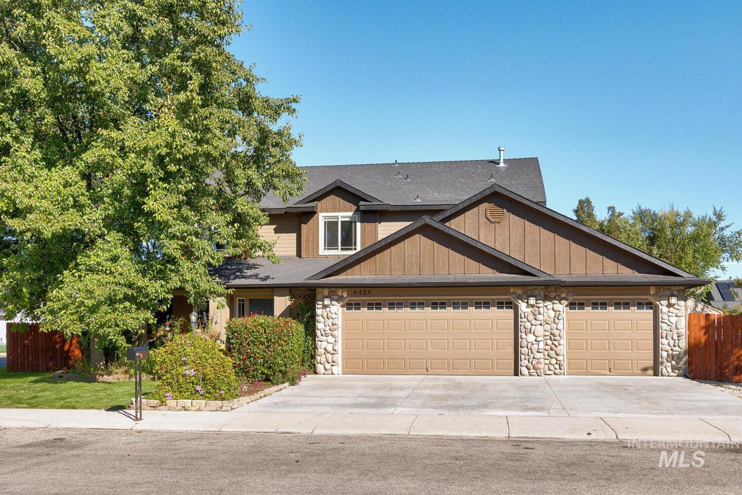 Craftsman house featuring stone siding, concrete driveway, a garage, and a shingled roof