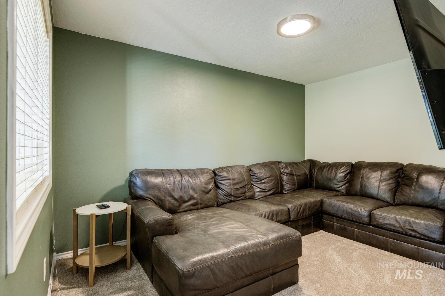 4428 West Campfire Street Meridian, ID 83646 - Photo 20 of 46 Carpeted living area with a textured ceiling and baseboards