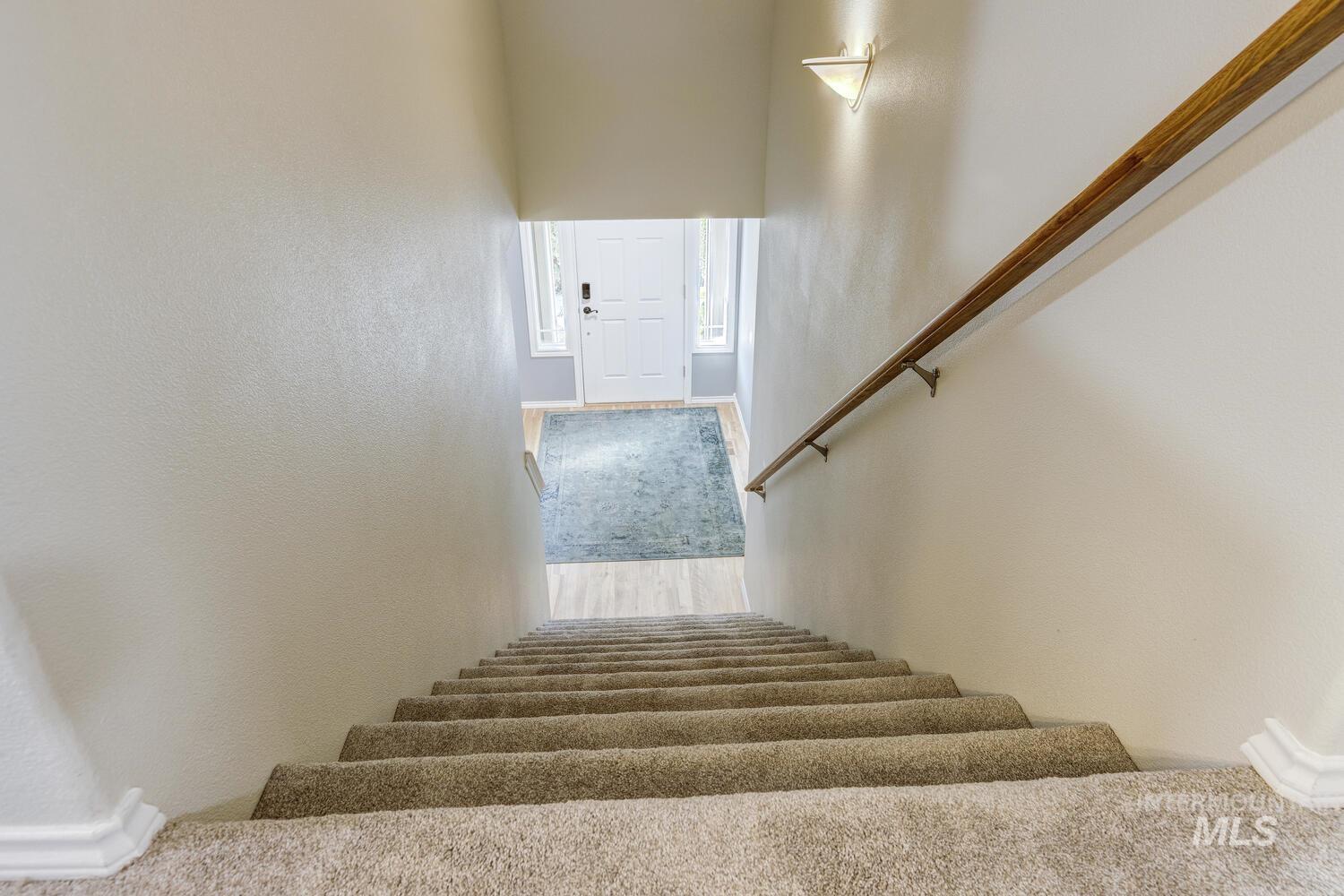 4428 West Campfire Street Meridian, ID 83646 - Photo 23 of 46 Stairs featuring wood finished floors and a textured wall