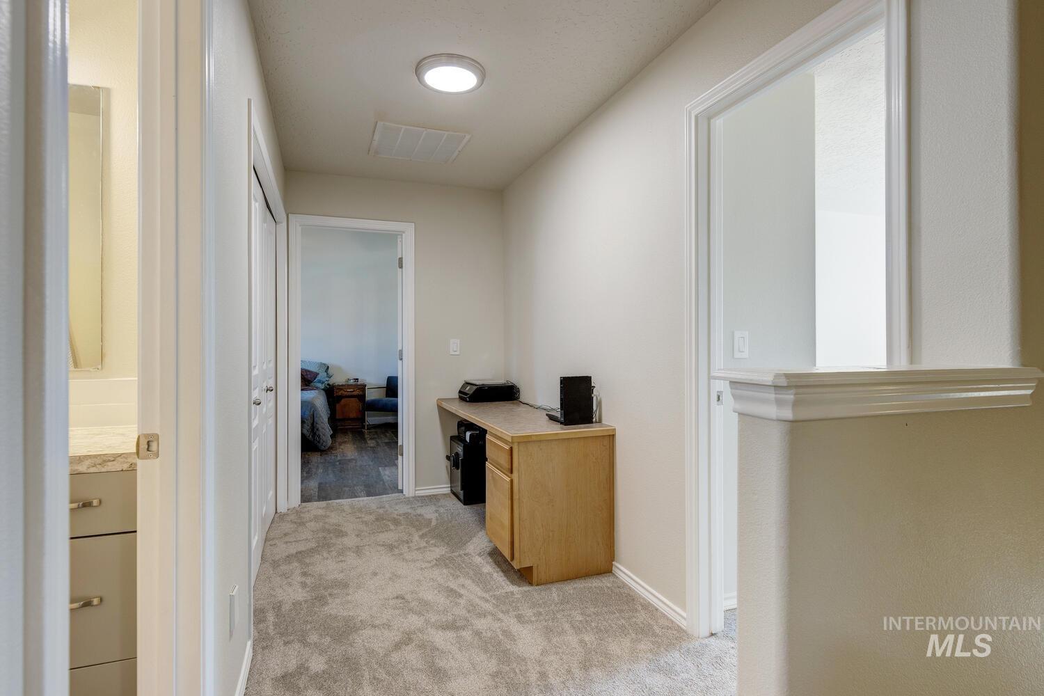 4428 West Campfire Street Meridian, ID 83646 - Photo 24 of 46 Hall with light colored carpet and baseboards