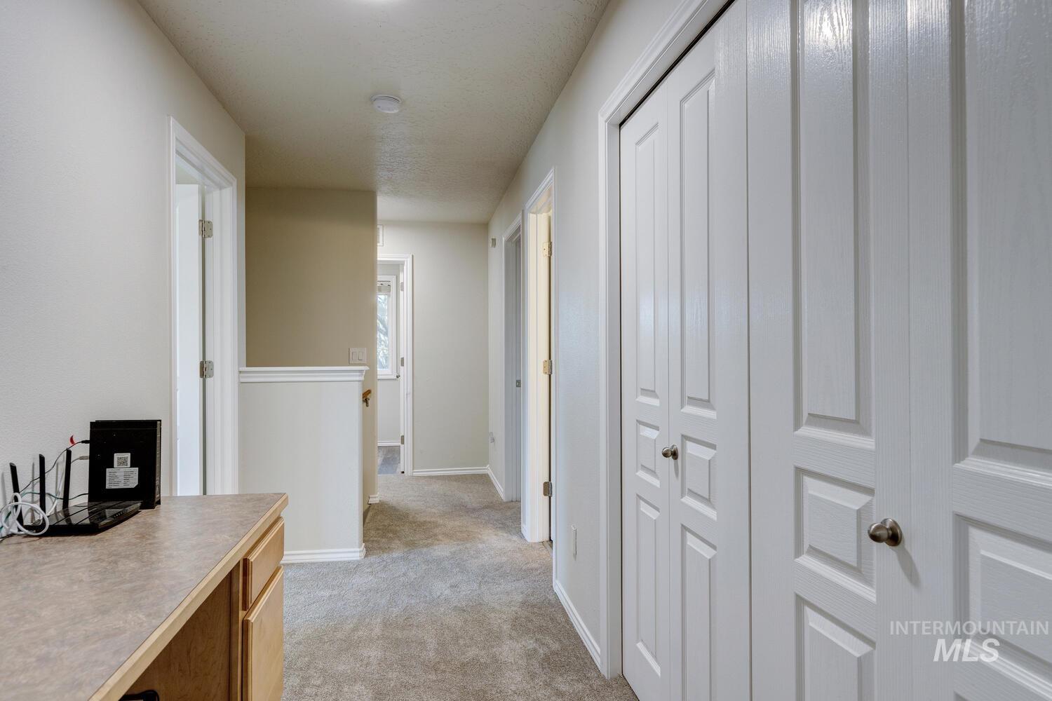 4428 West Campfire Street Meridian, ID 83646 - Photo 25 of 46 Corridor with light carpet and baseboards