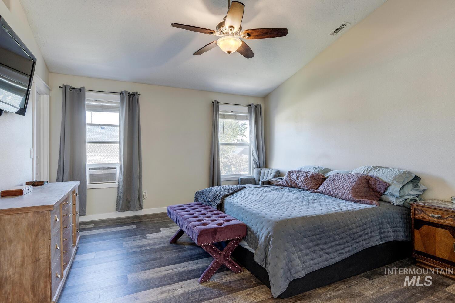 4428 West Campfire Street Meridian, ID 83646 - Photo 27 of 46 Bedroom with lofted ceiling, dark wood-style floors, a ceiling fan, and cooling unit
