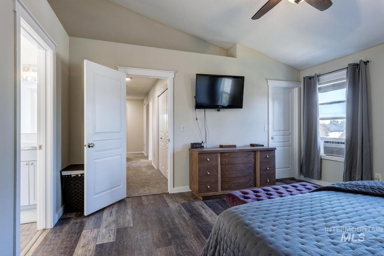 4428 West Campfire Street Meridian, ID 83646 - Photo 28 of 46 Bedroom featuring dark wood-style flooring, a closet, vaulted ceiling, and a ceiling fan