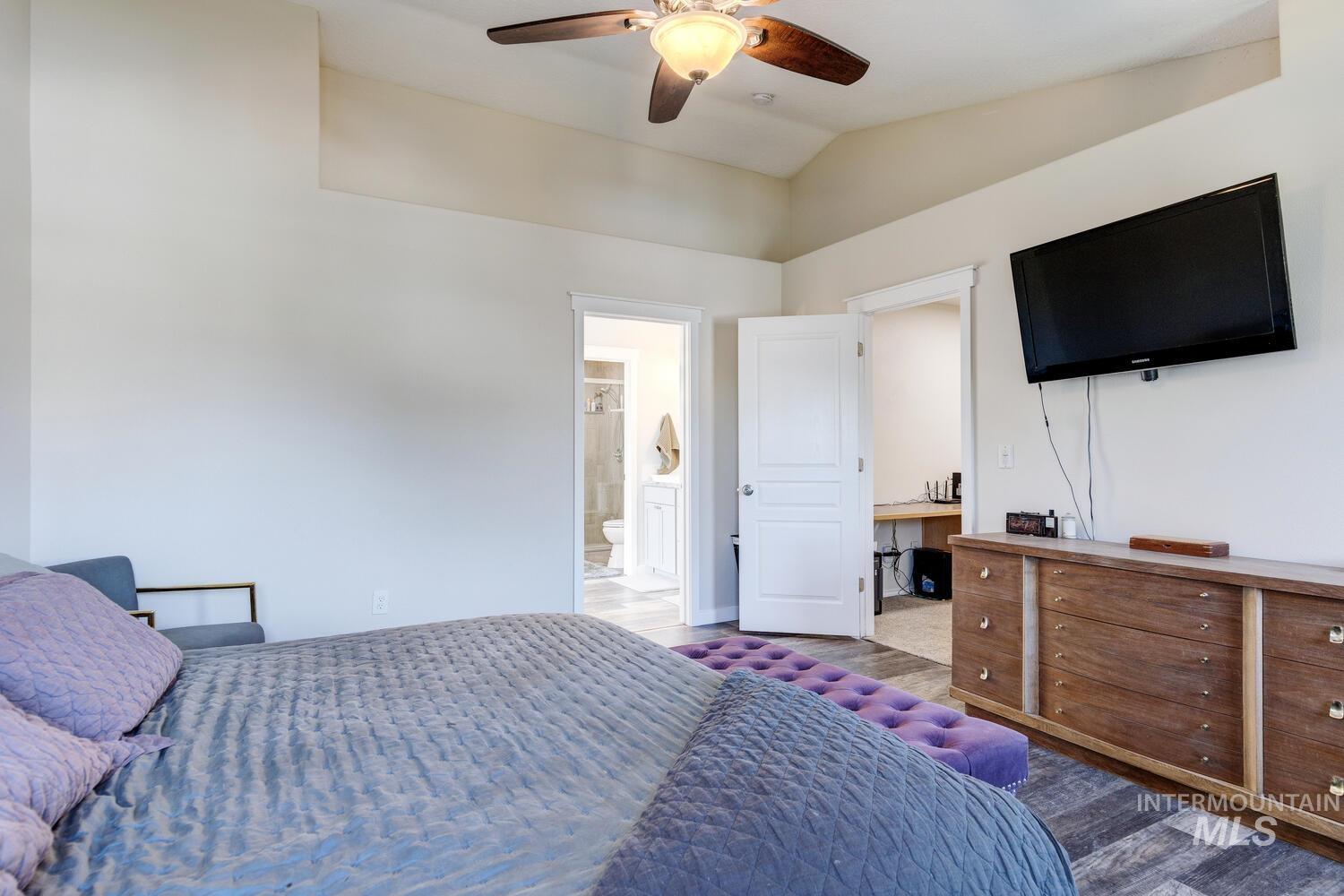 4428 West Campfire Street Meridian, ID 83646 - Photo 29 of 46 Bedroom with lofted ceiling, a ceiling fan, ensuite bathroom, and wood finished floors