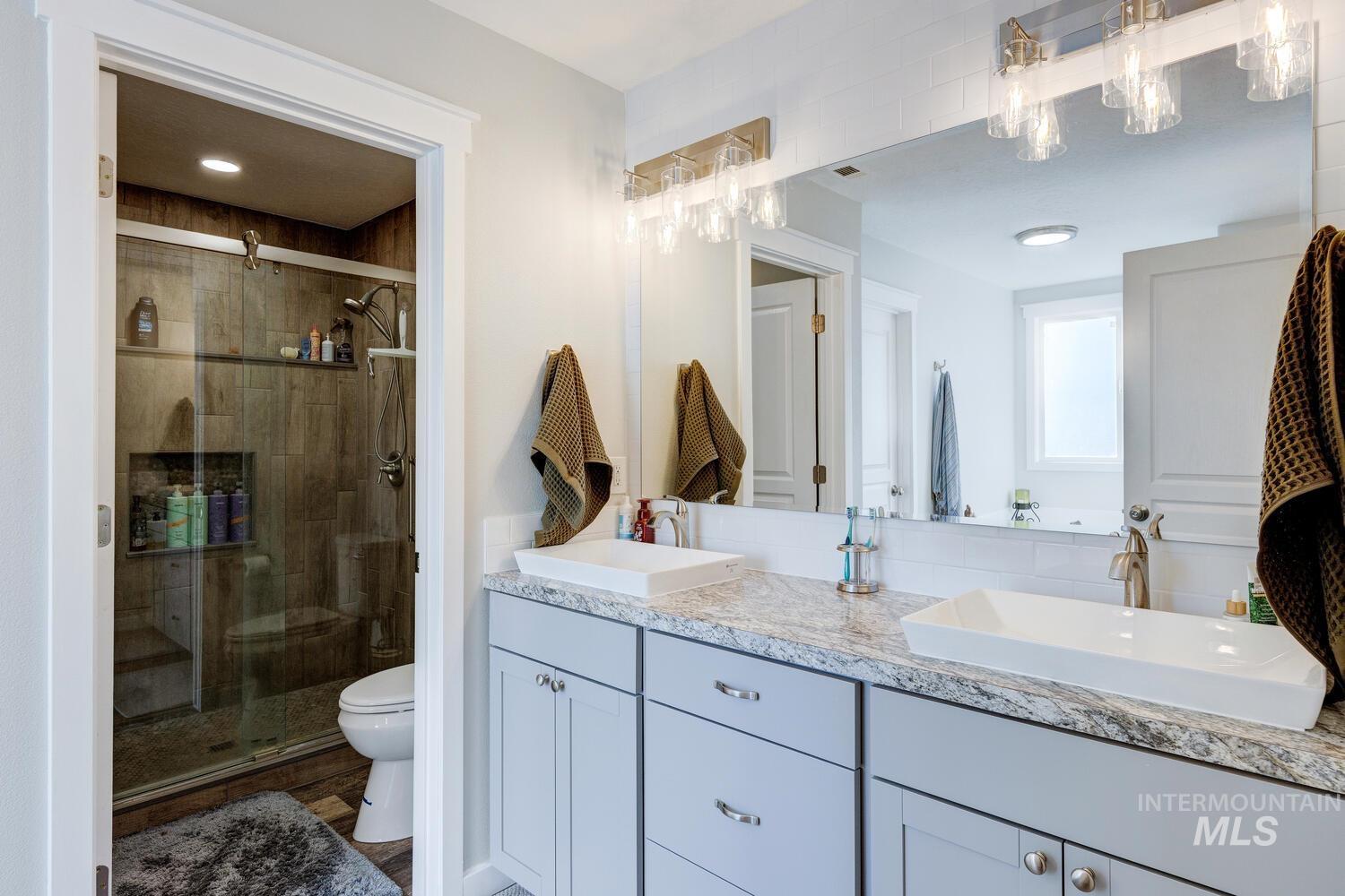 4428 West Campfire Street Meridian, ID 83646 - Photo 30 of 46 Bathroom with double vanity and a shower stall