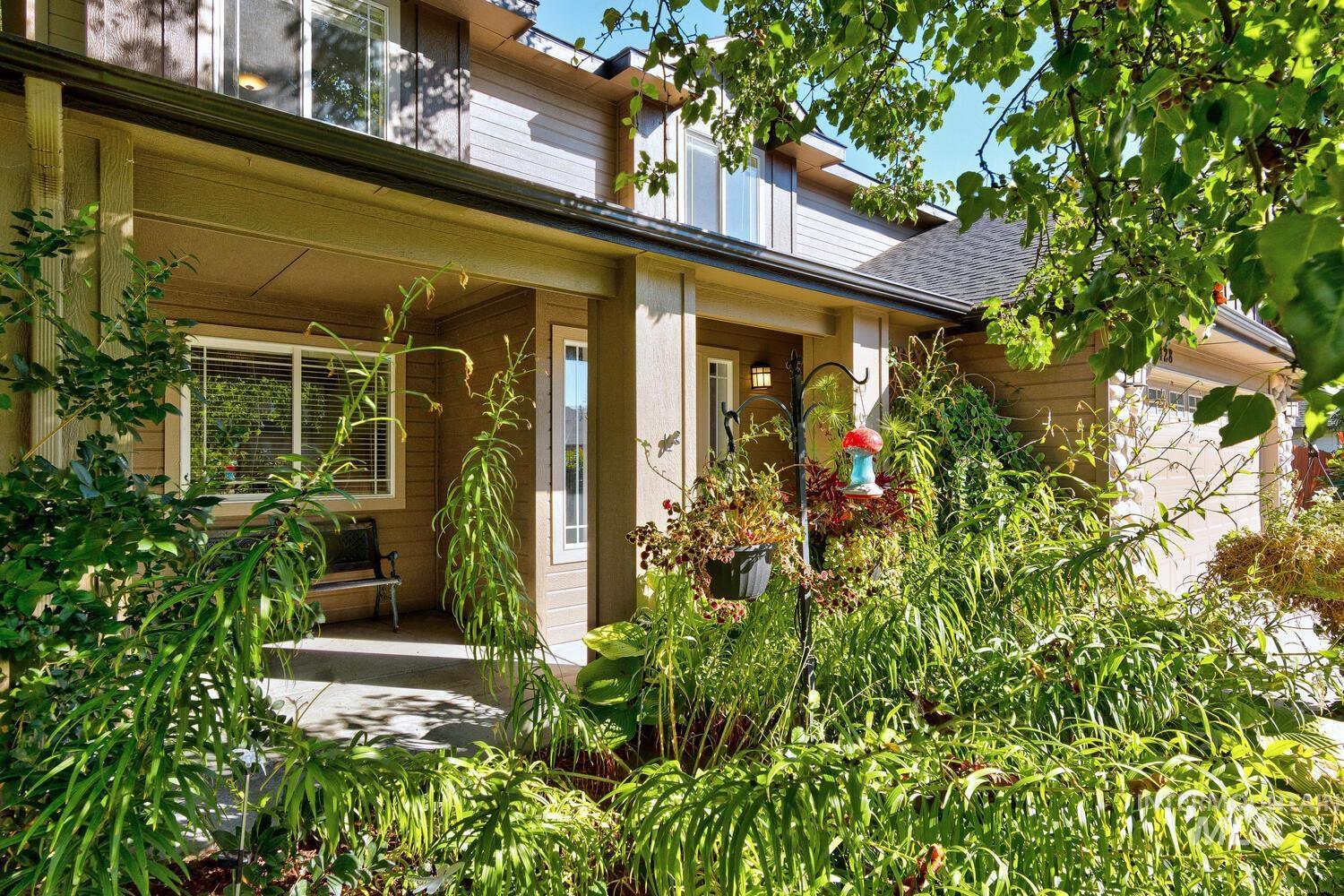 4428 West Campfire Street Meridian, ID 83646 - Photo 3 of 46 Property entrance featuring an attached garage, brick siding, and a shingled roof