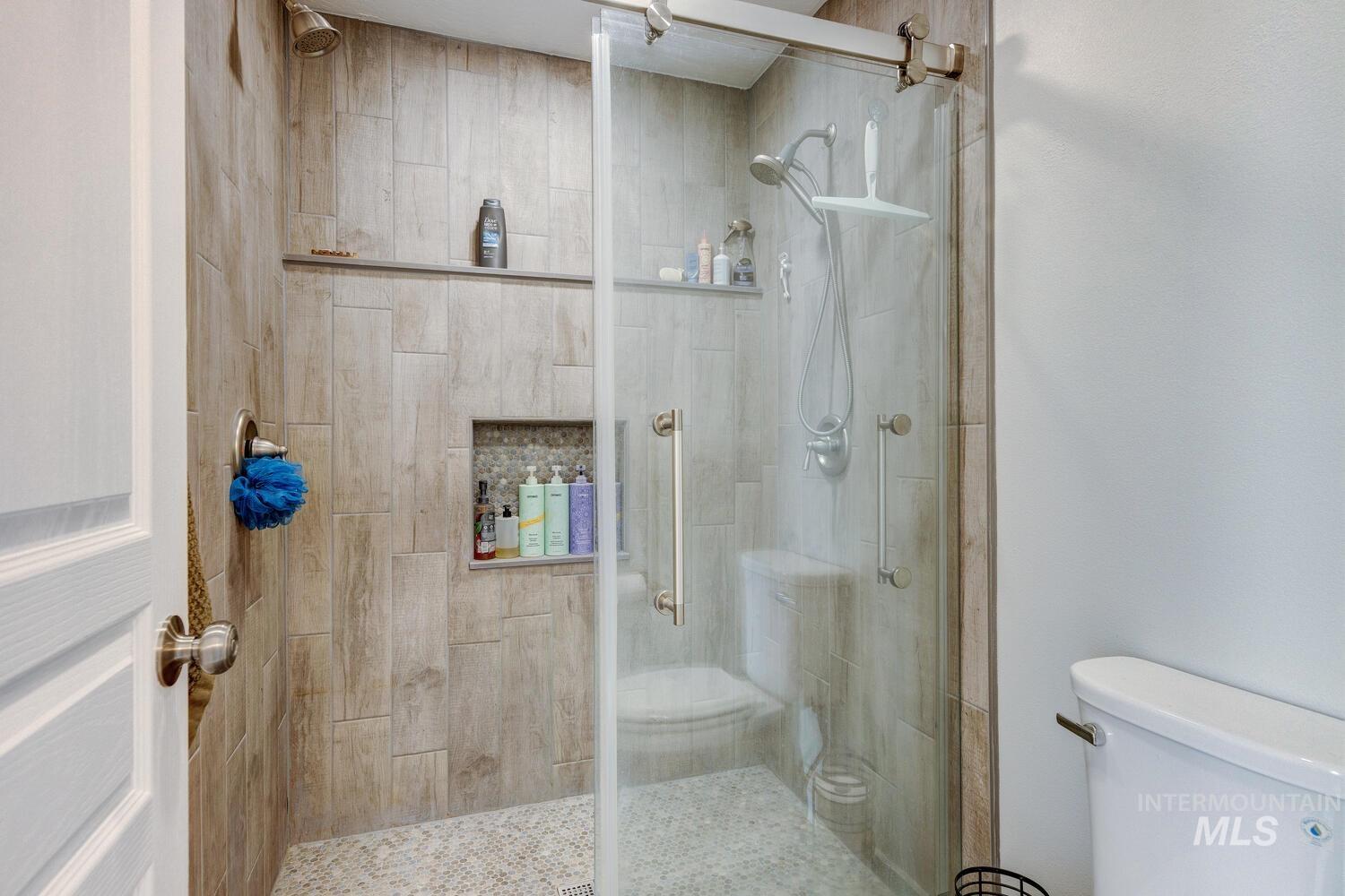 4428 West Campfire Street Meridian, ID 83646 - Photo 32 of 46 Bathroom featuring a stall shower and toilet