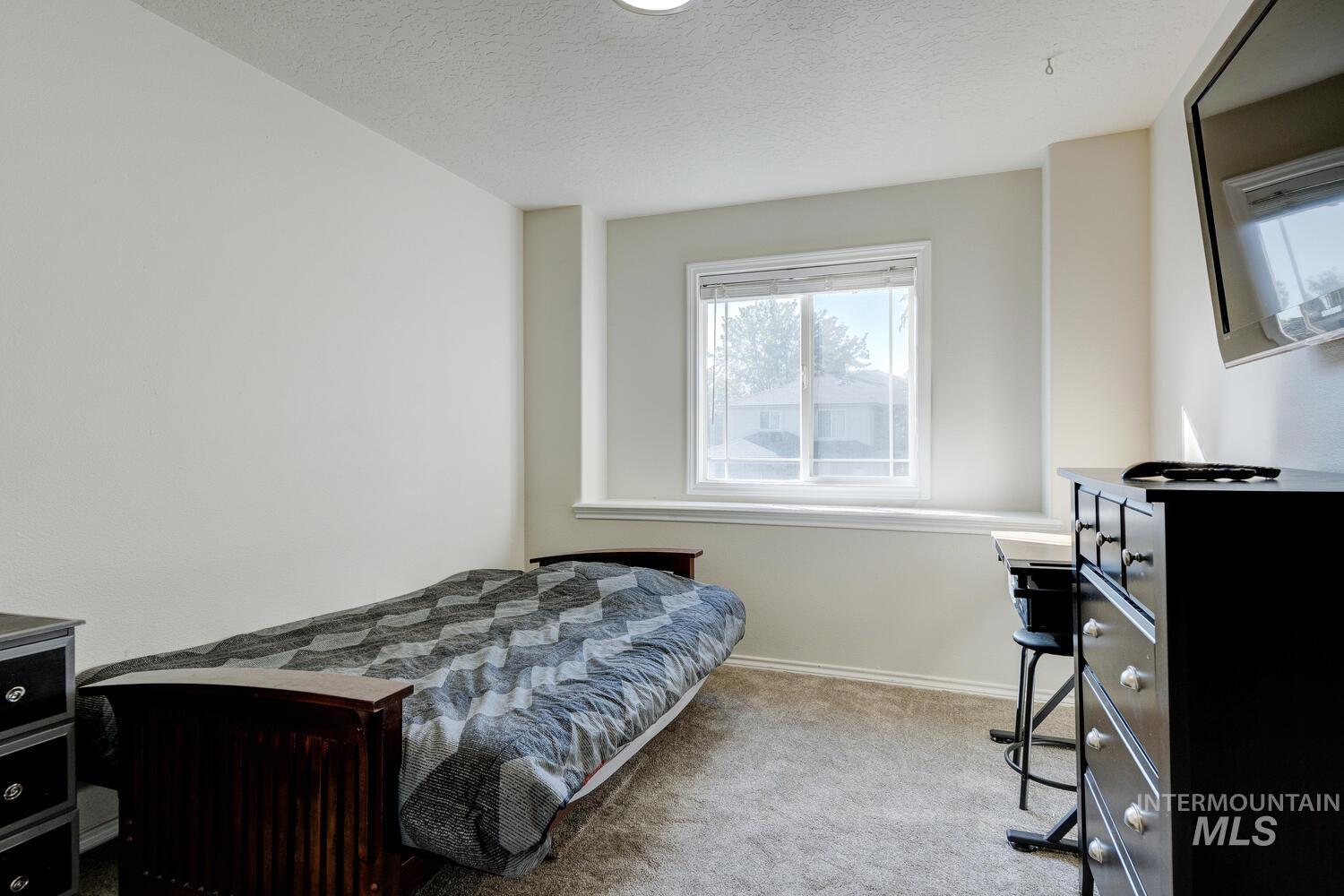 4428 West Campfire Street Meridian, ID 83646 - Photo 38 of 46 Bedroom featuring light carpet and a textured ceiling