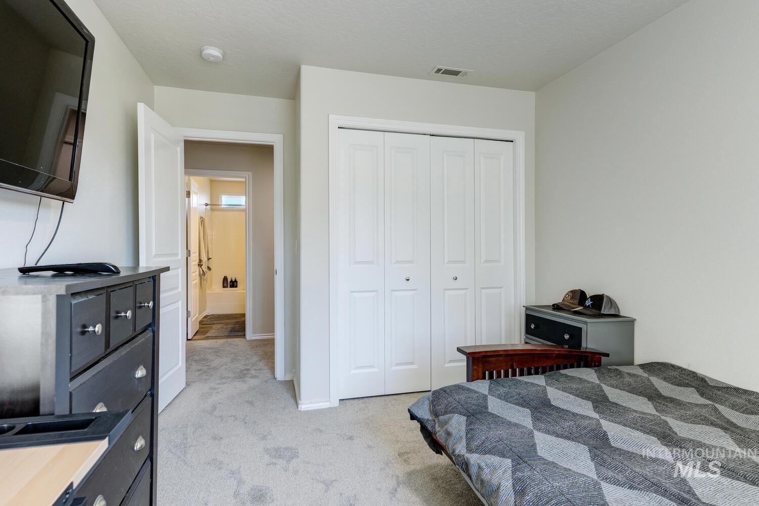 4428 West Campfire Street Meridian, ID 83646 - Photo 39 of 46 Bedroom featuring light colored carpet, a closet, and a textured ceiling